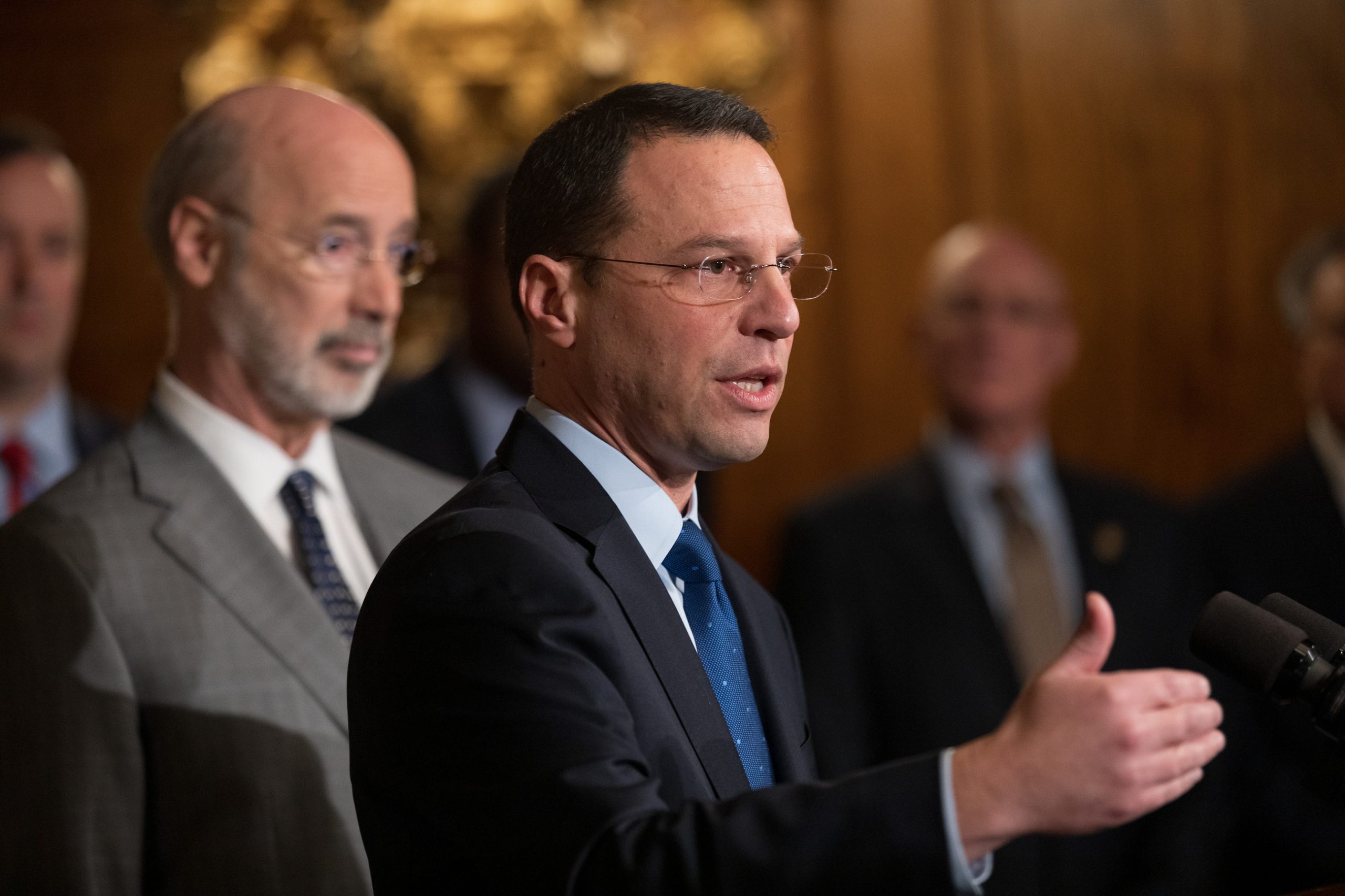 Pennsylvania Attorney General Josh Shapiro stands in front of state Gov. Tom Wolf.