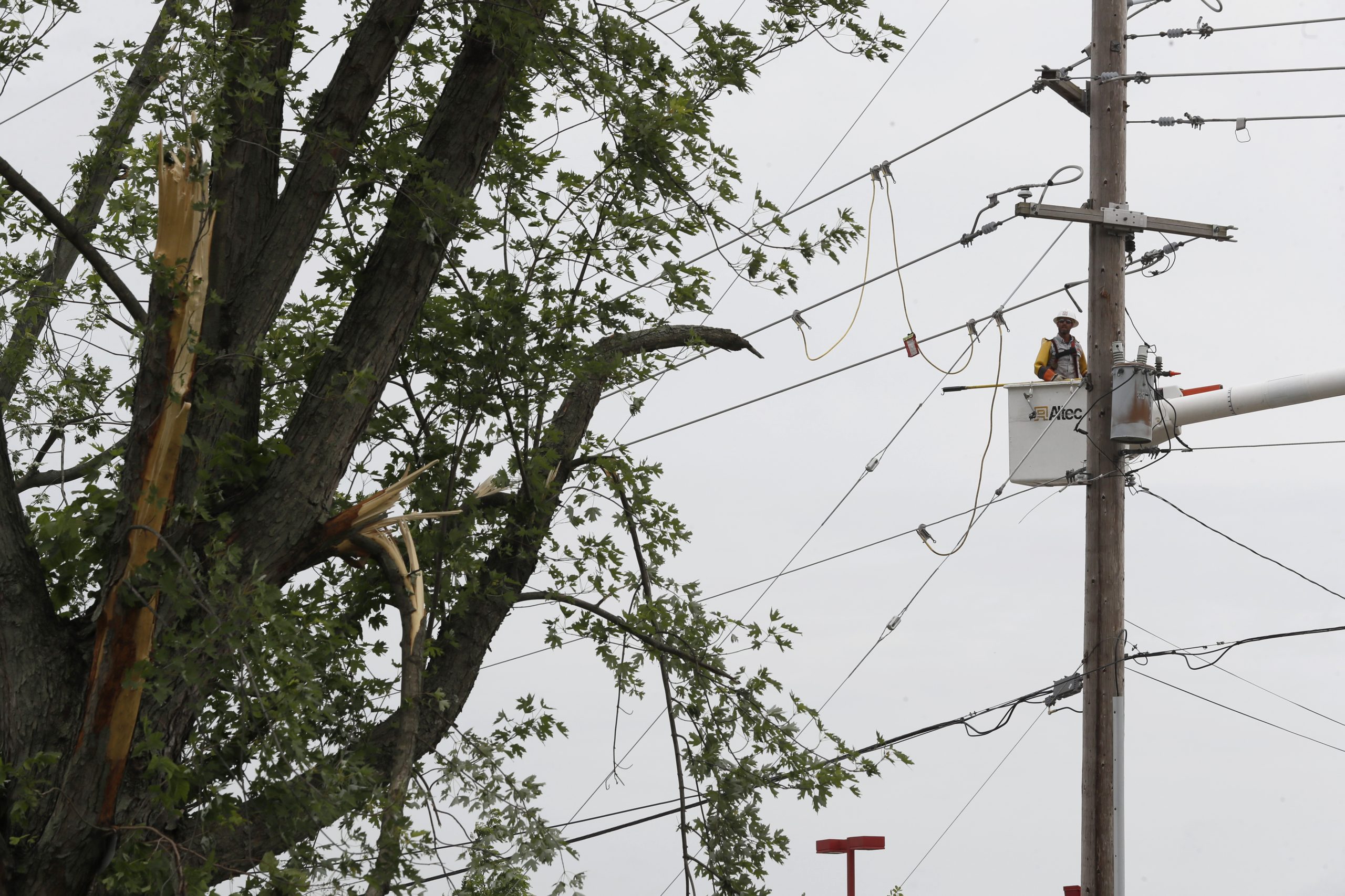 Utility workers address damaged power poles in May 2019, in Vandalia, Ohio, in the aftermath of strong tornadoes that spun through the Midwest.