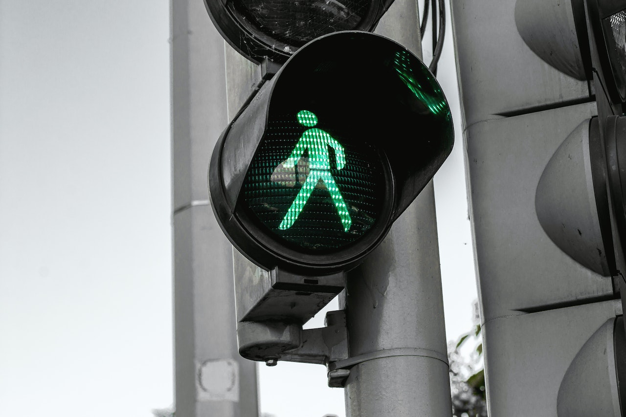 A walk sign, illuminated green.