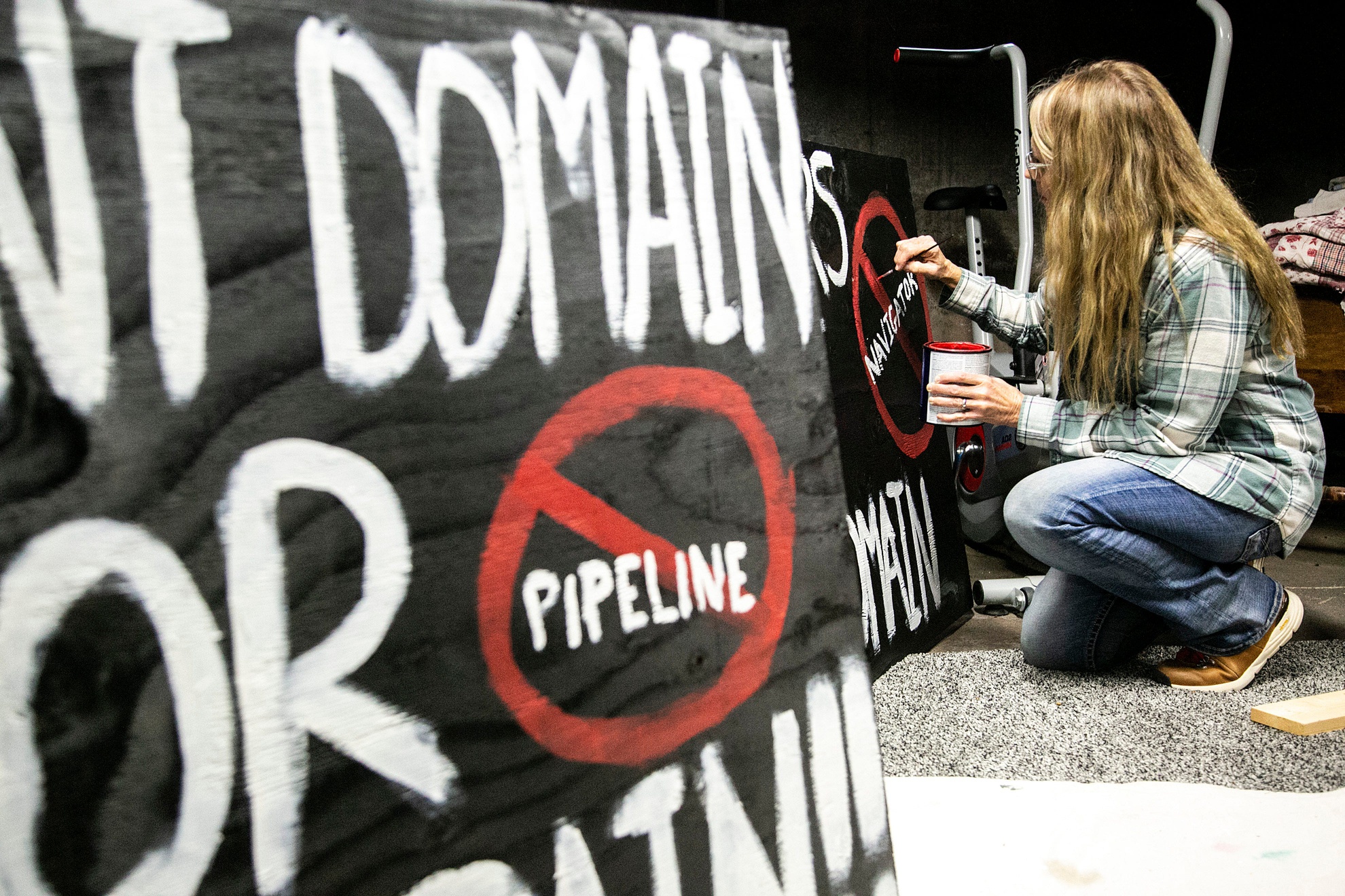 Residents opposed to a multi-state carbon pipeline gathered in Linn County, Iowa, to paint signs protesting the project in December 2021.
