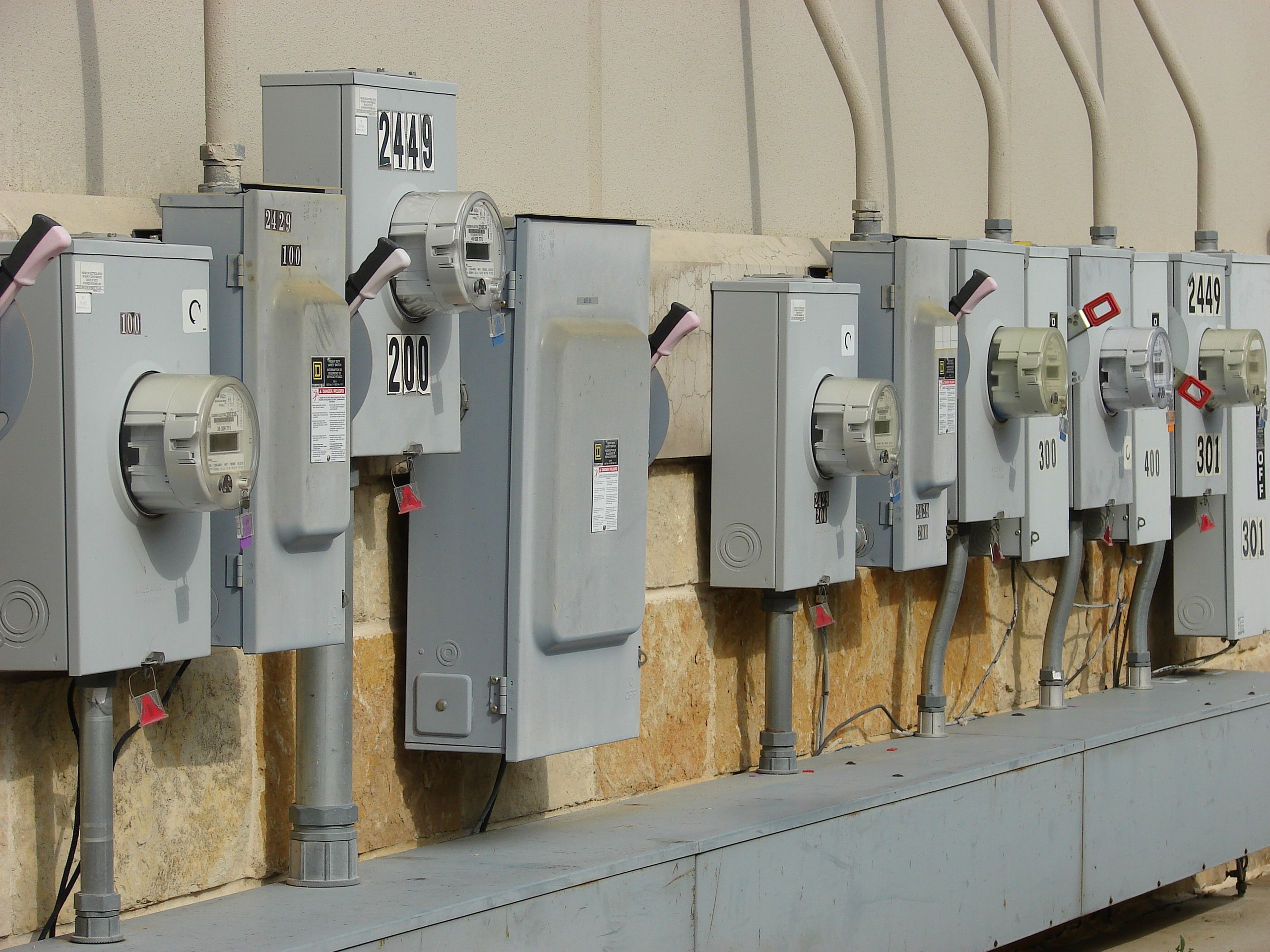 A wall of electrical boxes of different sizes and shapes.