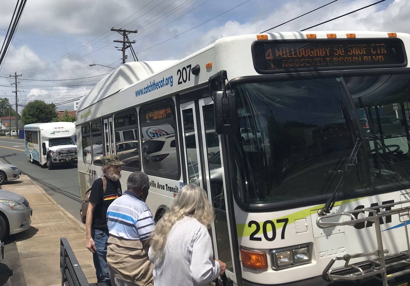 Passengers boarding a Charlottesville Area Transit bus.
